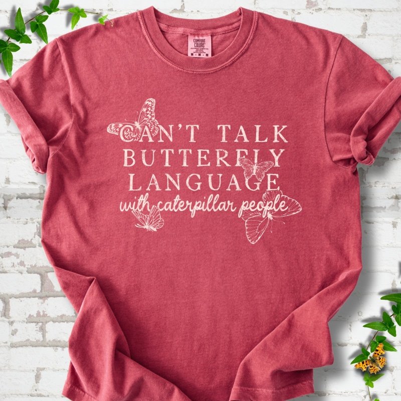 Crimson Comfort Colors® T-shirt featuring a cream Can't Talk Butterfly Language with Caterpillar People graphic with butterflies
