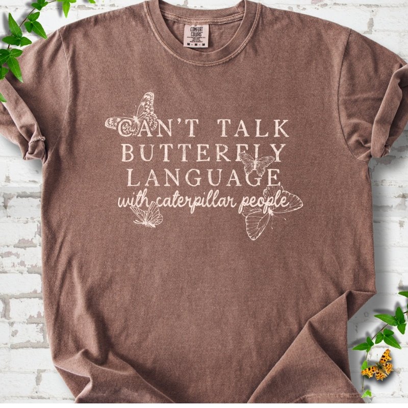 Espresso Comfort Colors® T-shirt featuring a cream Can't Talk Butterfly Language with Caterpillar People graphic with butterflies