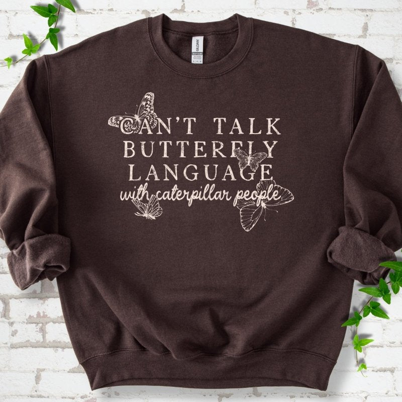 Dark Chocolate classic sweatshirt featuring a cream Can't Talk Butterfly Language with Caterpillar People graphic with butterflies