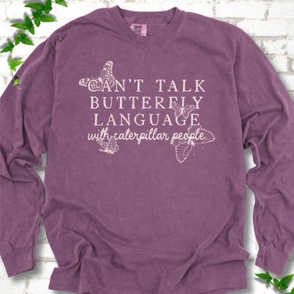 Berry Comfort Colors® long sleeve T-shirt featuring a cream Can't Talk Butterfly Language with Caterpillar People graphic with butterflies
