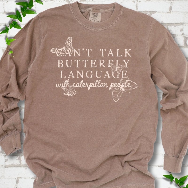 Espresso Comfort Colors® long sleeve T-shirt featuring a cream Can't Talk Butterfly Language with Caterpillar People graphic with butterflies