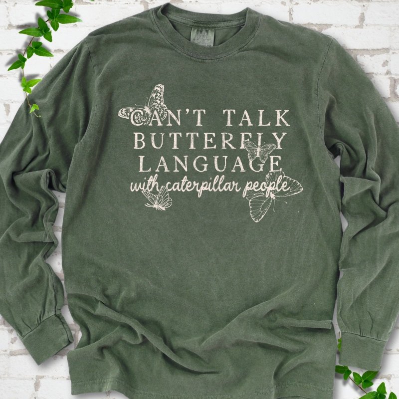 Hemp Comfort Colors® long sleeve T-shirt featuring a cream Can't Talk Butterfly Language with Caterpillar People graphic with butterflies