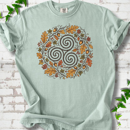 Bay Comfort Colors® T-shirt flat lay with a Celtic-inspired triskele and autumn oak wreath design.