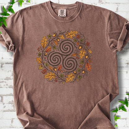 Espresso Comfort Colors® T-shirt flat lay with a Celtic-inspired triskele and autumn oak wreath design.