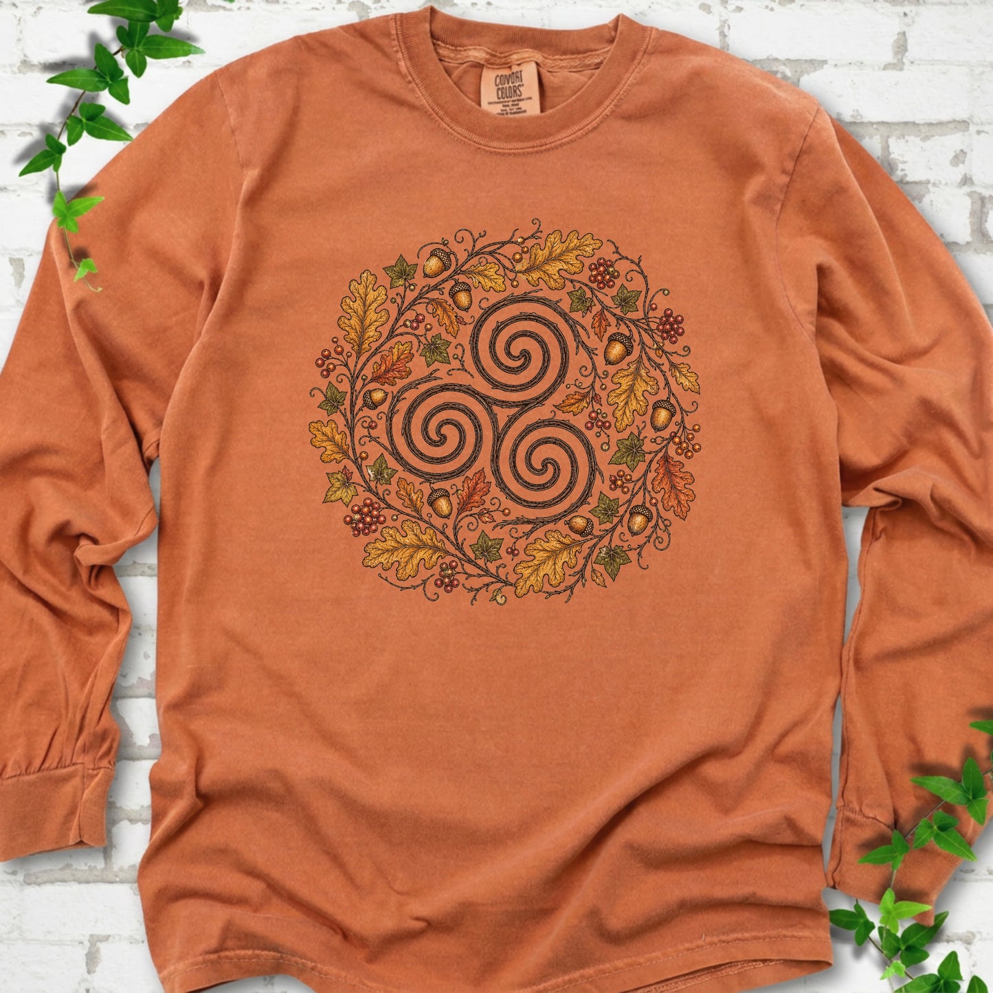 Yam Comfort Colors® long sleeve T-shirt flat lay with a Celtic-inspired triskele and autumn oak wreath design.