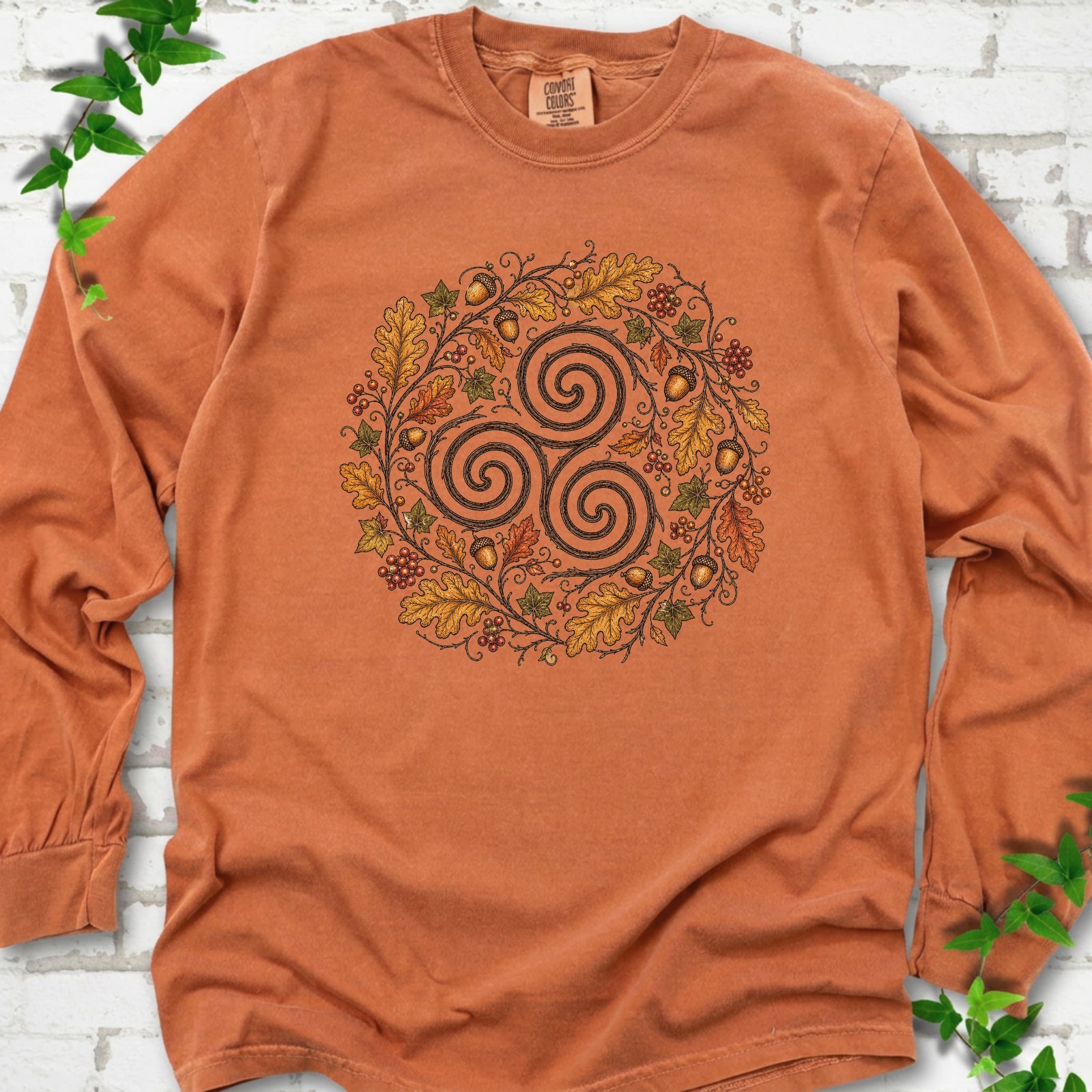 Yam Comfort Colors® long sleeve T-shirt flat lay with a Celtic-inspired triskele and autumn oak wreath design.