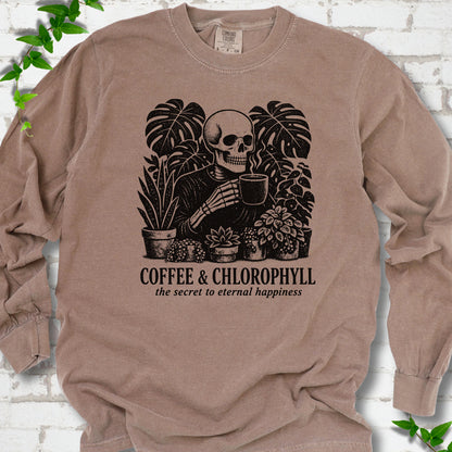 Espresso Comfort Colors® long sleeve T-shirt flat lay featuring a distressed skeleton drinking coffee among houseplants