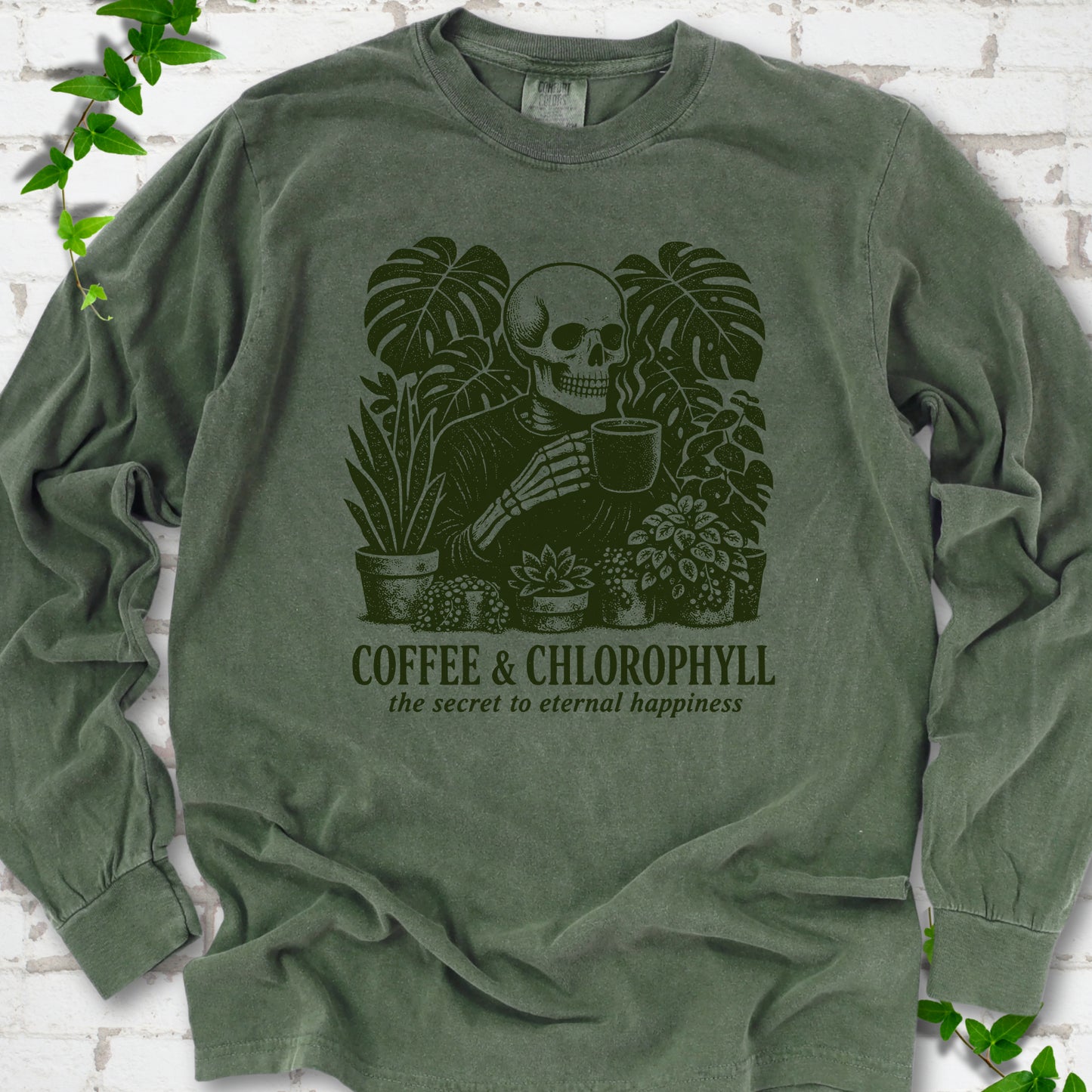 Hemp Comfort Colors® long sleeve T-shirt flat lay featuring a distressed skeleton drinking coffee among houseplants