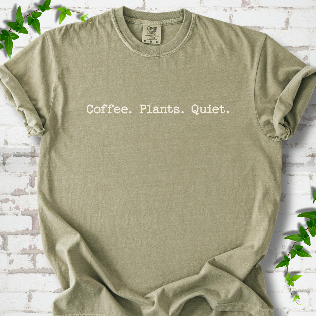 Khaki Comfort Colors® T-shirt showing the Coffee. Plants. Quiet. text design
