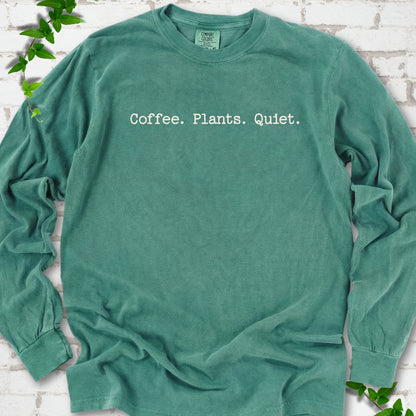 Light Green Comfort Colors® long sleeve T-shirt showing the Coffee. Plants. Quiet. text design