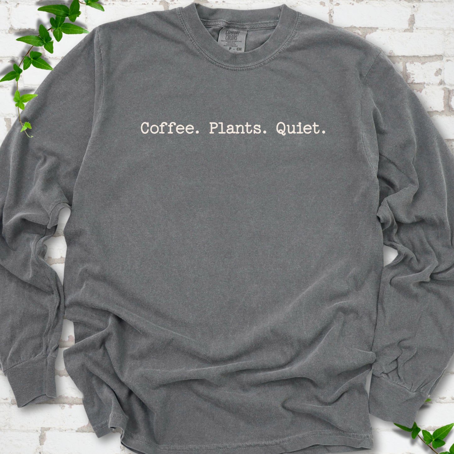 Pepper Comfort Colors® long sleeve T-shirt showing the Coffee. Plants. Quiet. text design