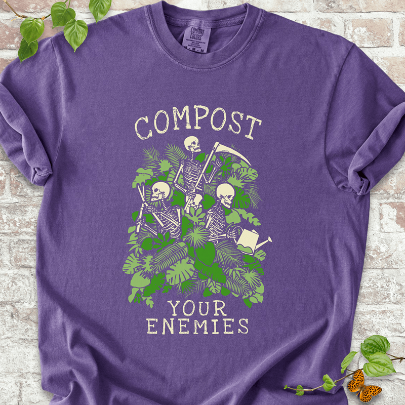 Compost Your Enemies Skeleton graphic on a Comfort Colors™ Pepper T-shirt – spooky garden design with skeletons, compost pile, and fall plants
