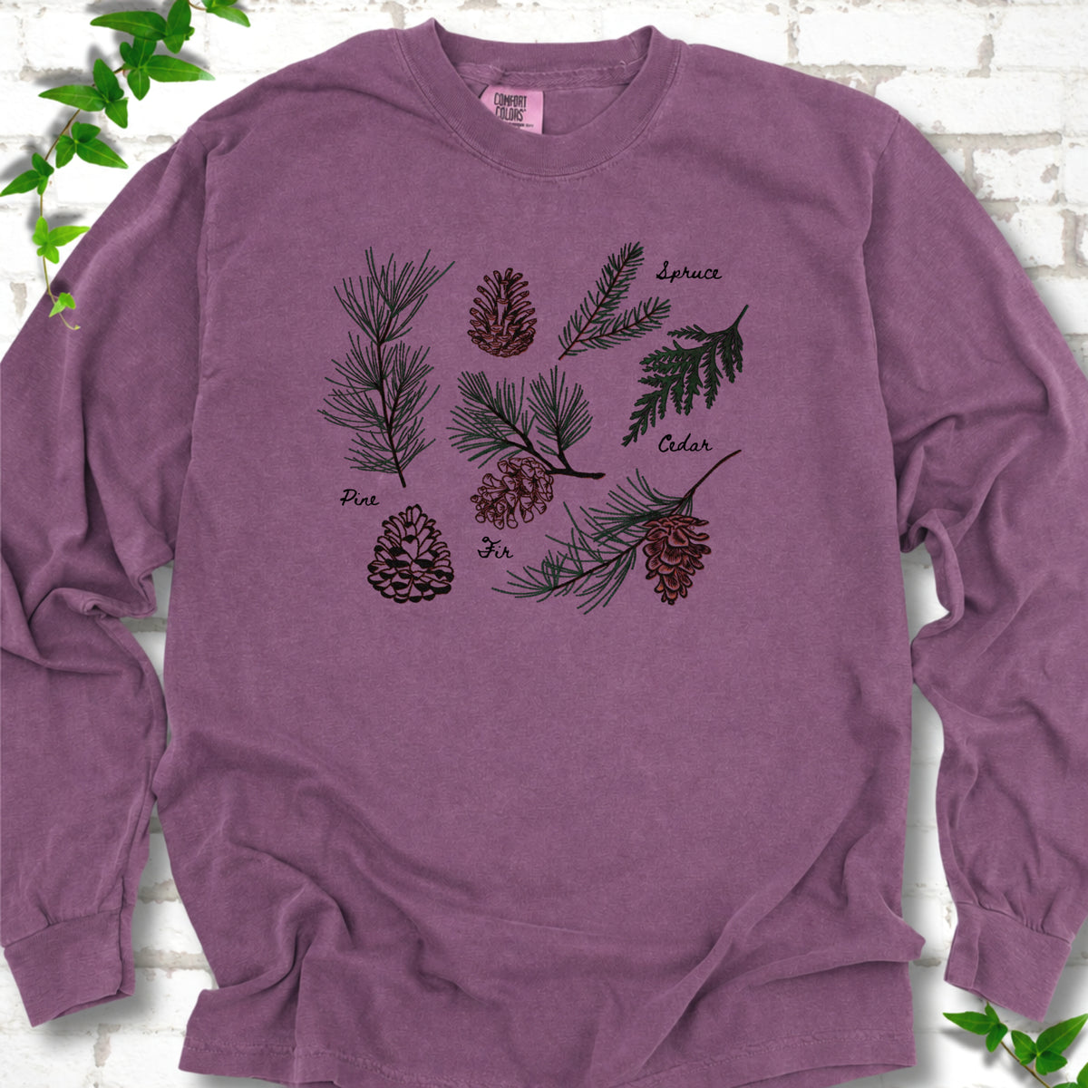 Berry Comfort Colors® long sleeve T-shirt shown flat with a botanical chart of pine, spruce, cedar and fir cones and needles