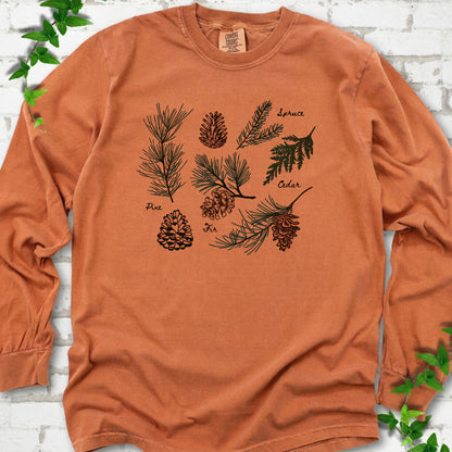 Yam Comfort Colors® long sleeve T-shirt shown flat with a botanical chart of pine, spruce, cedar and fir cones and needles