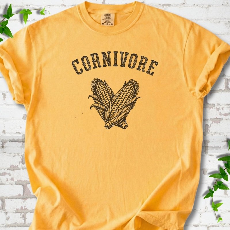 Citrus Comfort Colors® short sleeve T-shirt flat lay featuring black line art of two sweet corn cobs beneath the word "Cornivore"