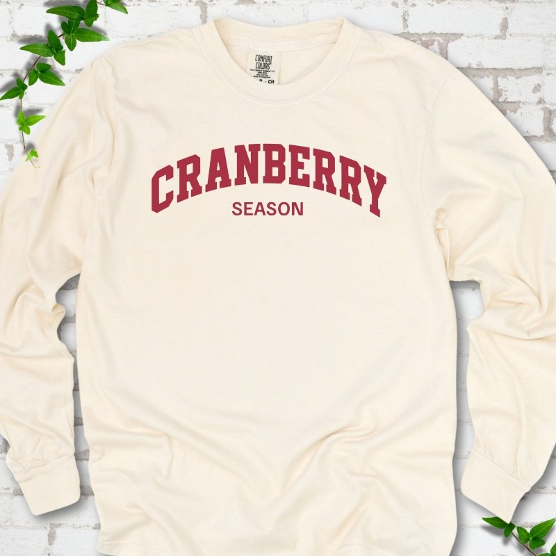Ivory Comfort Colors® long sleeve T-shirt with red collegiate-style Cranberry Season lettering