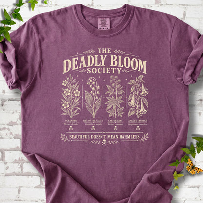 Berry Comfort Colors® T-shirt flat lay featuring The Deadly Bloom Society poisonous plant design.