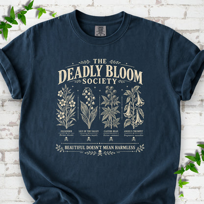 Midnight Comfort Colors® T-shirt flat lay featuring The Deadly Bloom Society poisonous plant design.