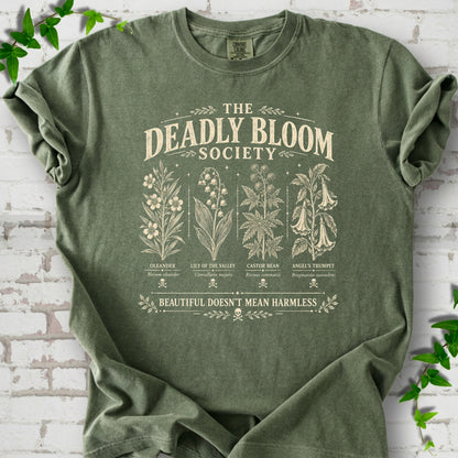 Moss Comfort Colors® T-shirt flat lay featuring The Deadly Bloom Society poisonous plant design.
