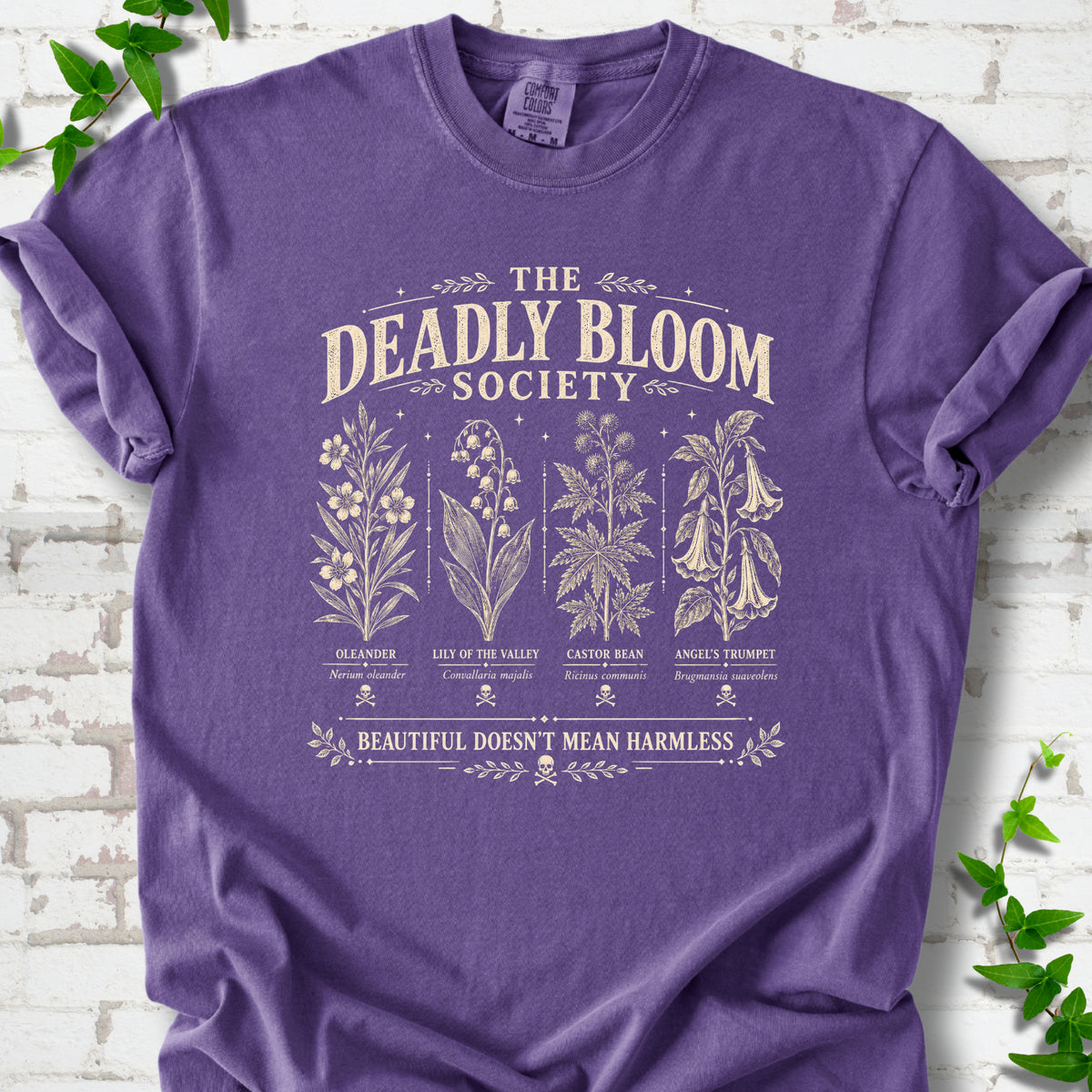 Grape Comfort Colors® T-shirt flat lay featuring The Deadly Bloom Society poisonous plant design.