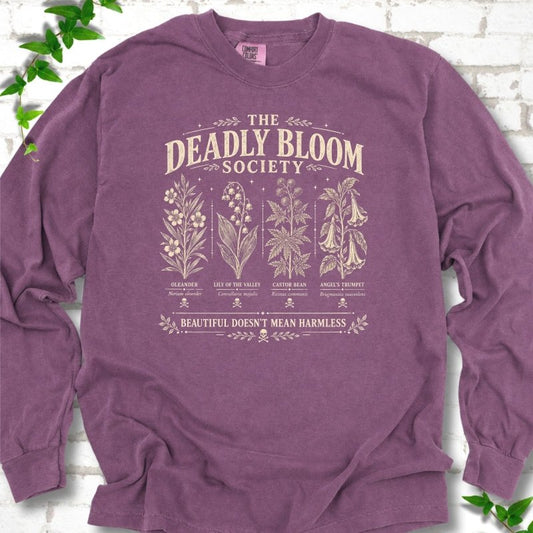 Berry Comfort Colors® long sleeve T-shirt flat lay featuring The Deadly Bloom Society poisonous plant design.