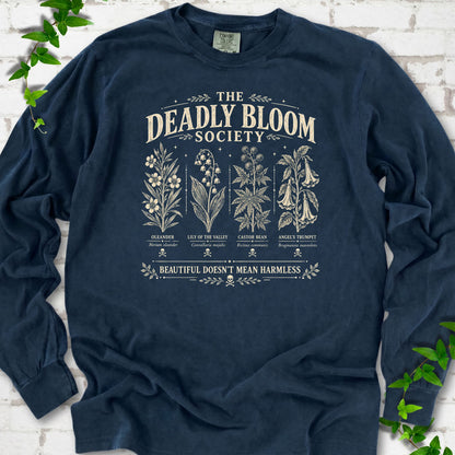 Midnight Comfort Colors® long sleeve T-shirt flat lay featuring The Deadly Bloom Society poisonous plant design.