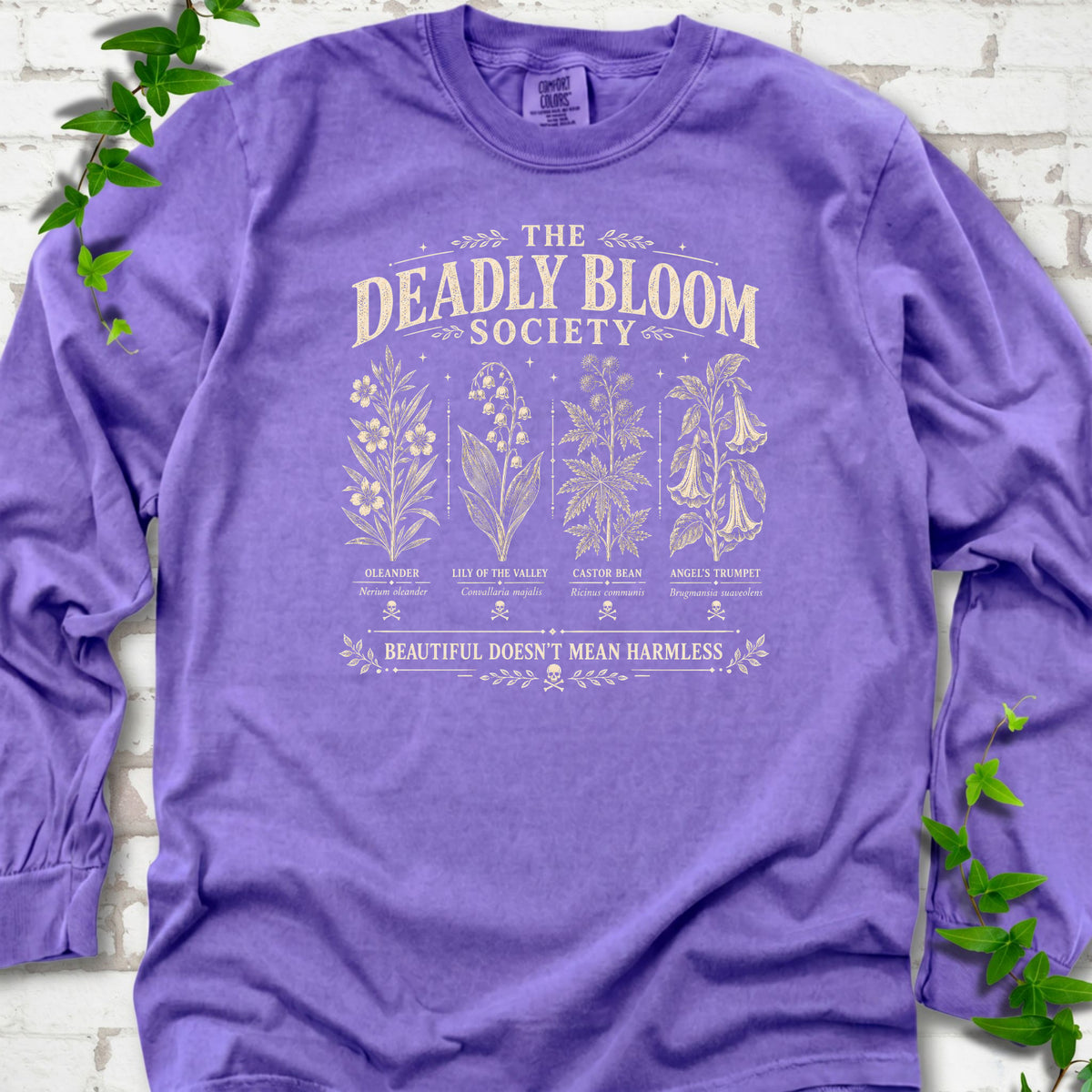 Violet Comfort Colors® long sleeve T-shirt flat lay featuring The Deadly Bloom Society poisonous plant design.