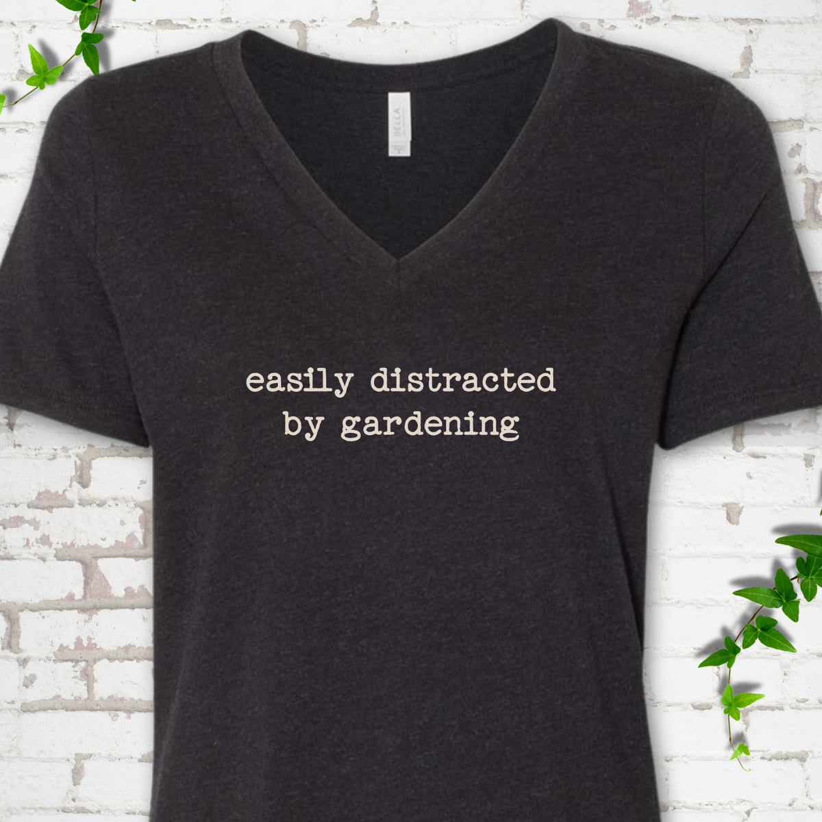 Heather Black women's V-neck T-shirt with Easily Distracted by Gardening text design.