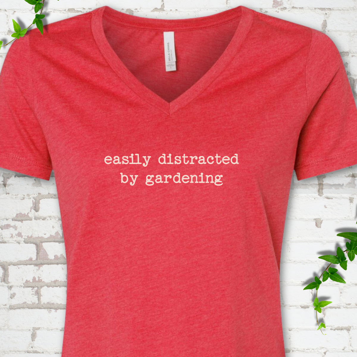 Heather Red women's V-neck T-shirt with Easily Distracted by Gardening text design.