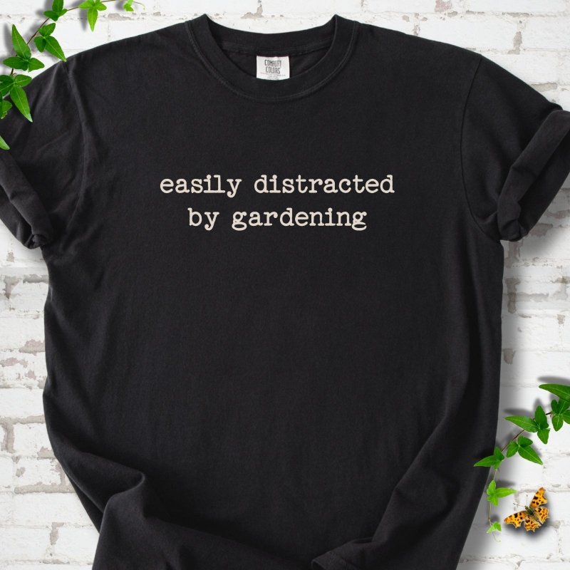 Black Comfort Colors® T-shirt with Easily Distracted by Gardening text design.
