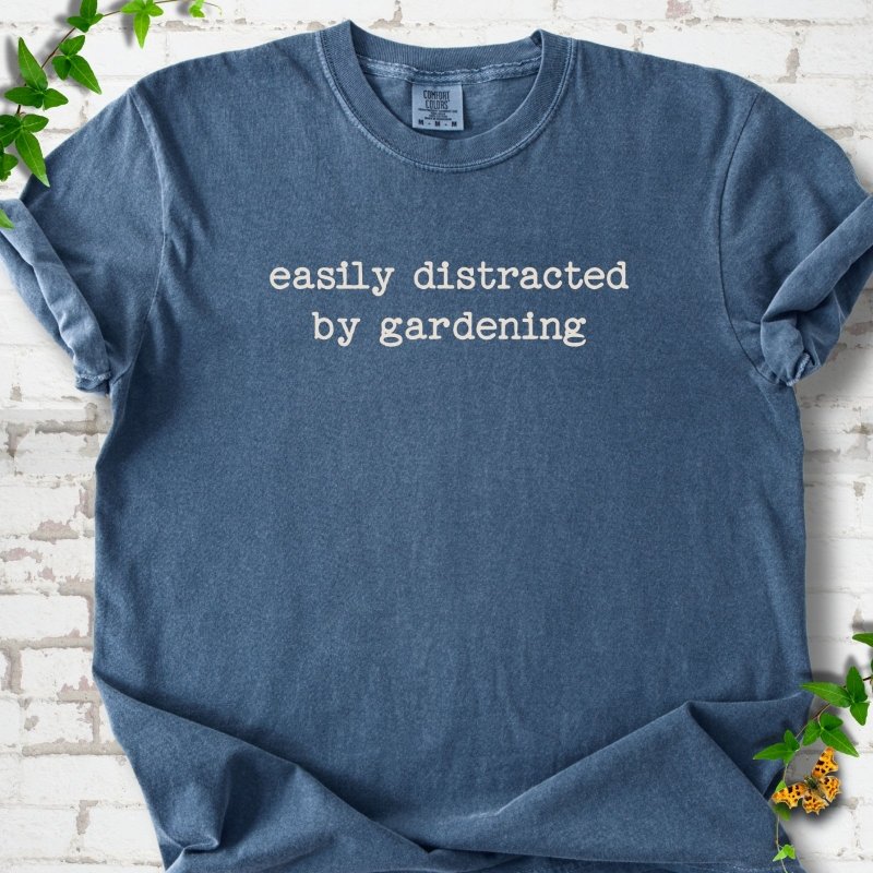 Denim Comfort Colors® T-shirt with Easily Distracted by Gardening text design.