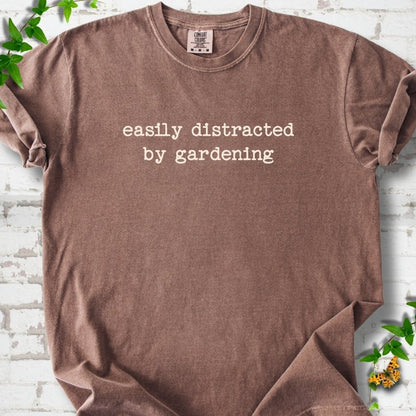 Espresso Comfort Colors® T-shirt with Easily Distracted by Gardening text design.