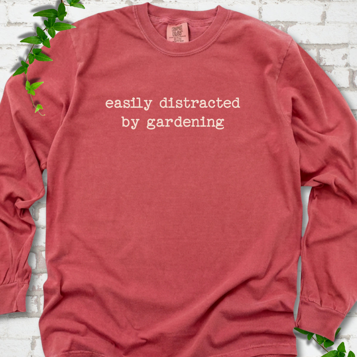 Crimson Comfort Colors® long sleeve shirt with Easily Distracted by Gardening text design.