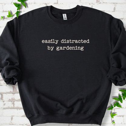 Black classic sweatshirt with Easily Distracted by Gardening text design.