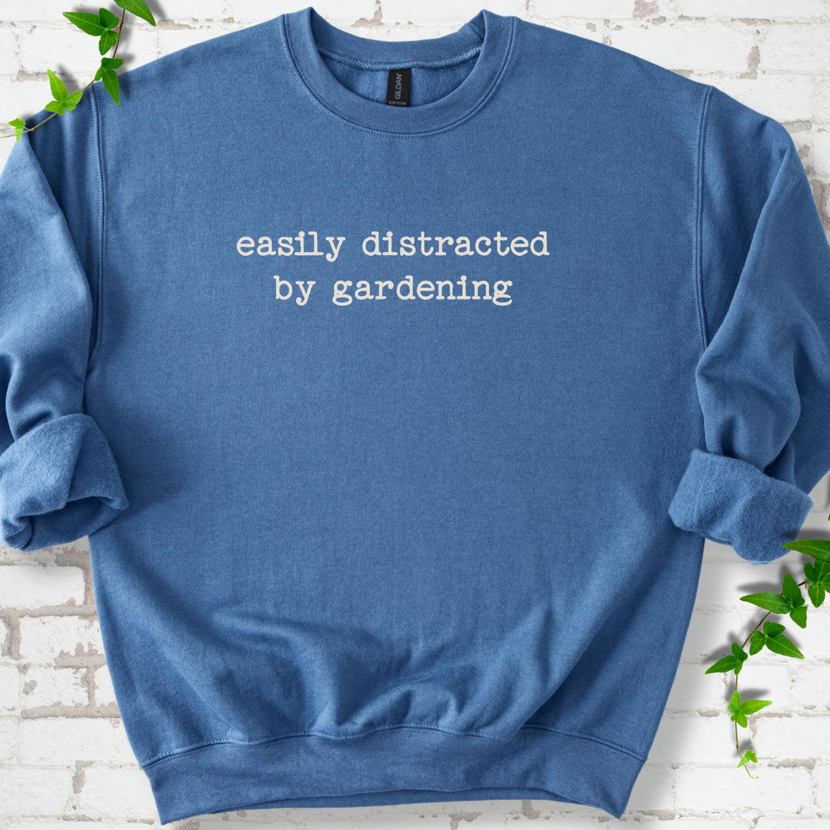 Indigo classic sweatshirt with Easily Distracted by Gardening text design.
