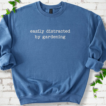 Indigo classic sweatshirt with Easily Distracted by Gardening text design.