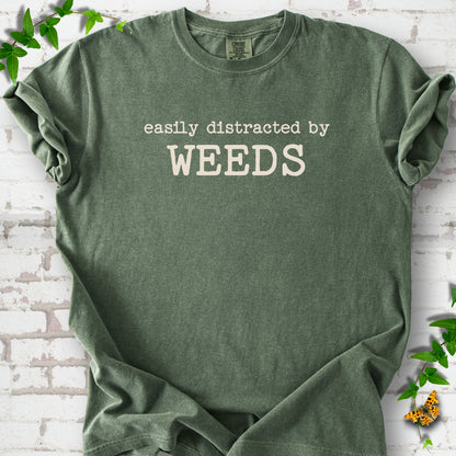 Moss Comfort Colors® T-shirt shown flat with cream "Easily Distracted by Weeds" gardening slogan