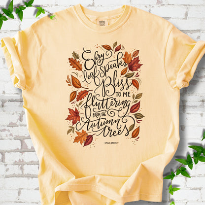 Butter Comfort Colors® T-shirt flat lay with the Every Leaf Speaks Bliss Emily Brontë quote and autumn leaves.