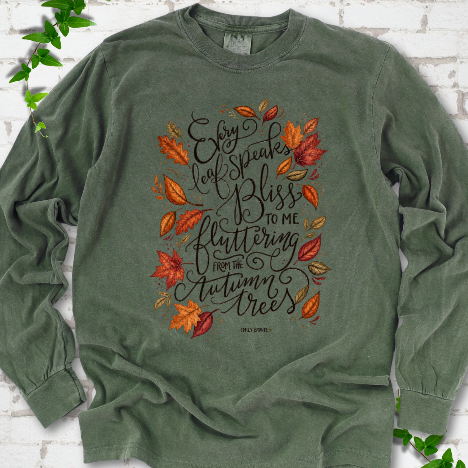 Hemp Comfort Colors® long sleeve T-shirt flat lay with the Every Leaf Speaks Bliss Emily Brontë quote and autumn leaves.