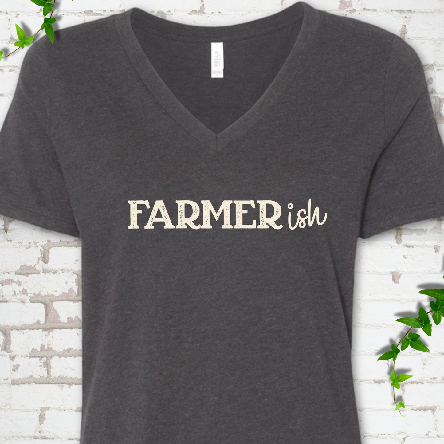 Dark Grey Heather Bella Canvas® V-neck T-shirt front mockup featuring the distressed FARMERish typographic design.
