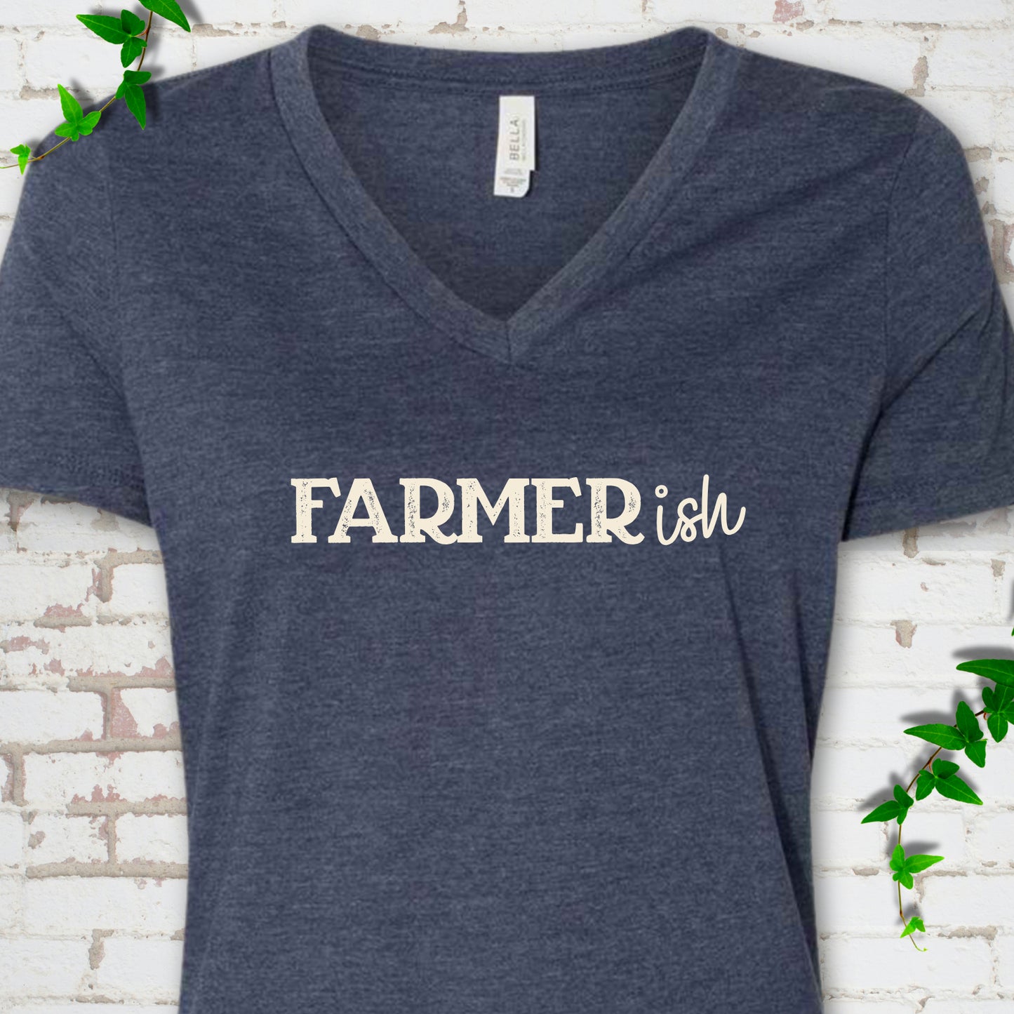 Heather Navy Bella Canvas® V-neck T-shirt front mockup featuring the distressed FARMERish typographic design.
