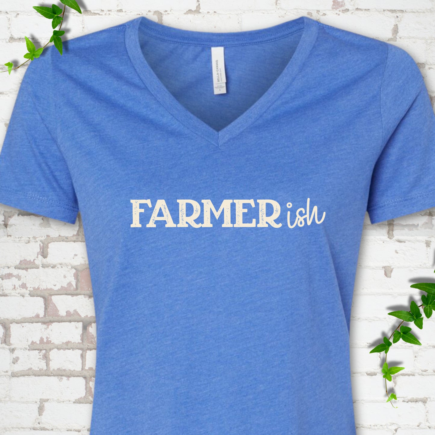 Heather True Royal Bella Canvas® V-neck T-shirt front mockup featuring the distressed FARMERish typographic design.