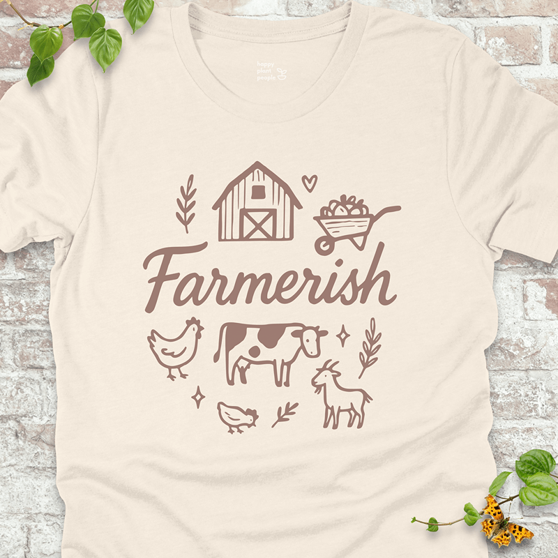 Light beige tee with cozy homesteader design and white ink print. Breathable, soft, and perfect for veggie growers.