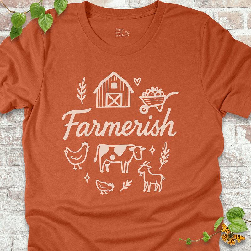 Rust-orange Bella+Canvas tee with farmhouse icons and ‘Farmerish’ script. Fall-inspired and garden-friendly.