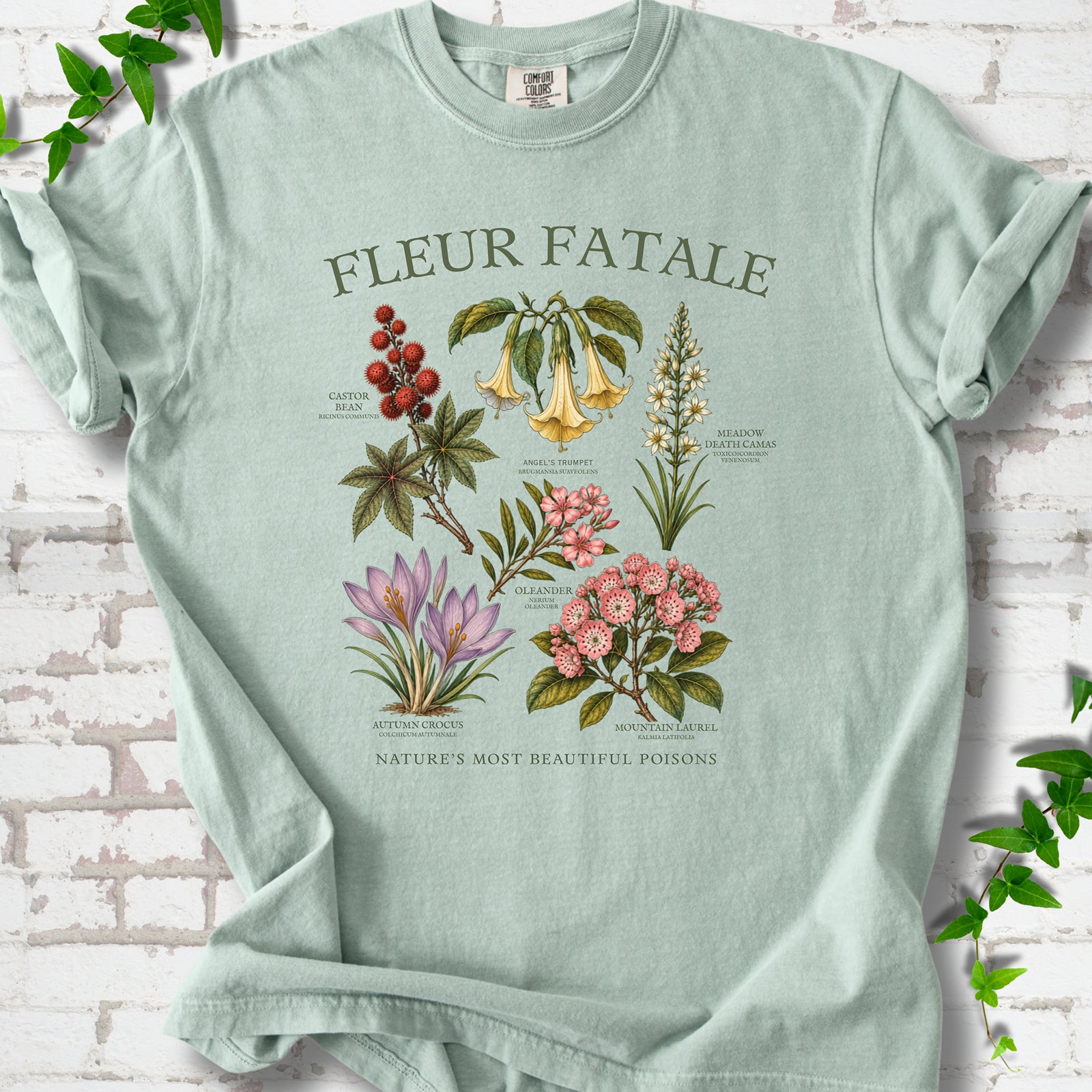 Bay Comfort Colors® T-shirt flat lay featuring a Fleur Fatale botanical chart of six poisonous flowering plants.