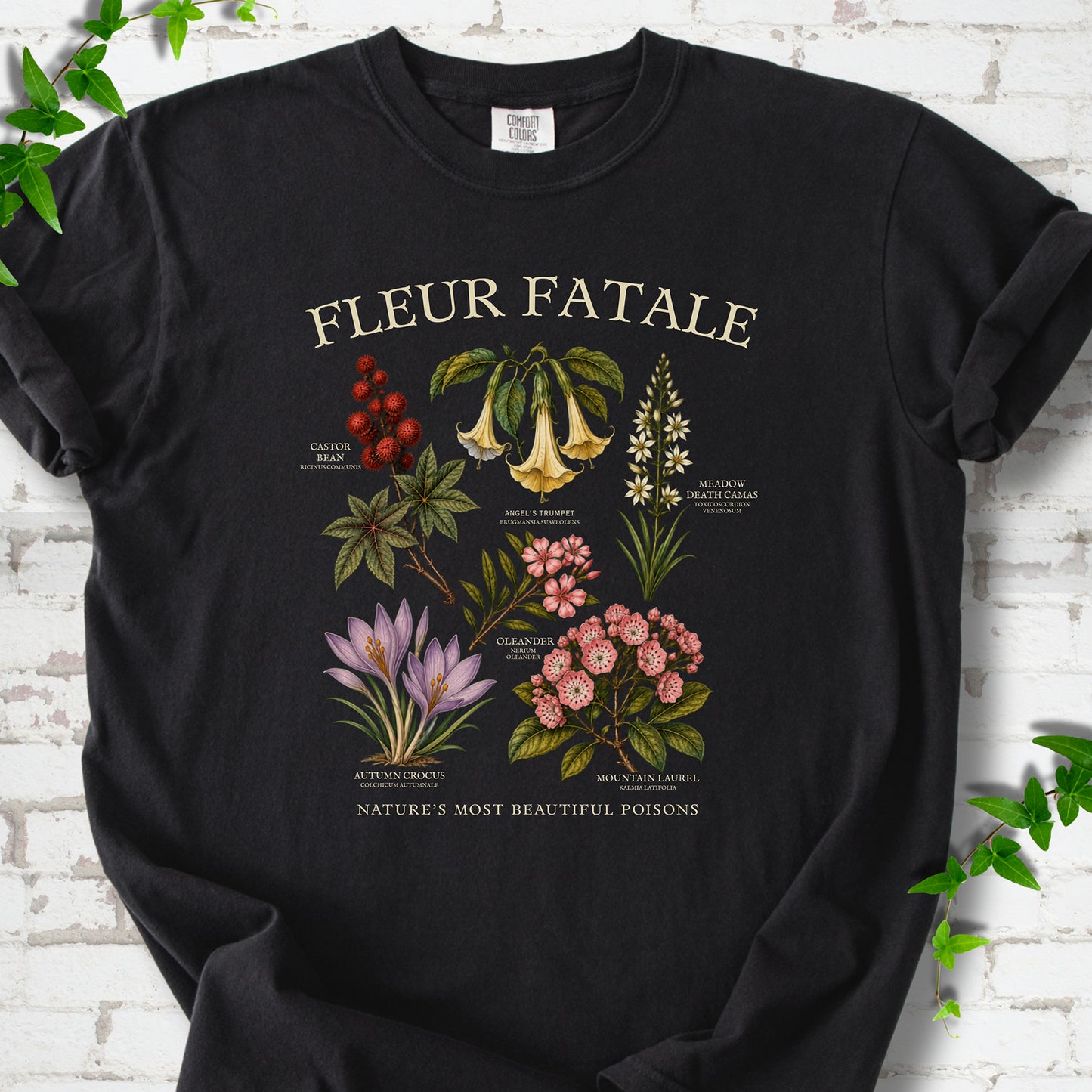 Black Comfort Colors® T-shirt flat lay featuring a Fleur Fatale botanical chart of six poisonous flowering plants.