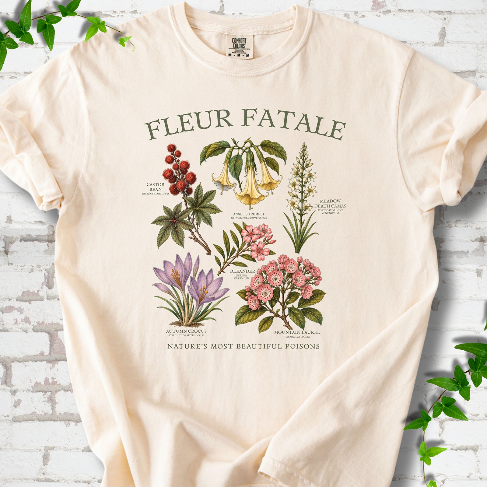 Ivory Comfort Colors® T-shirt flat lay featuring a Fleur Fatale botanical chart of six poisonous flowering plants.