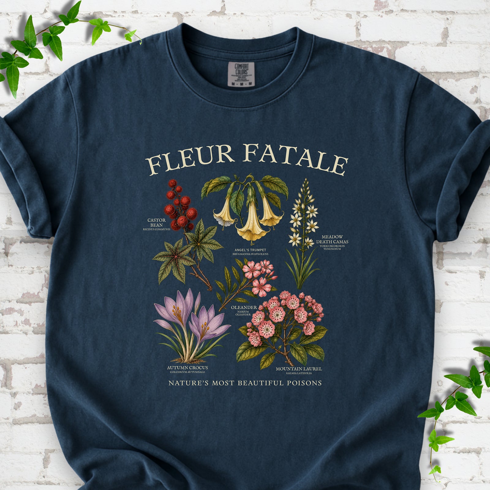 Midnight Comfort Colors® T-shirt flat lay featuring a Fleur Fatale botanical chart of six poisonous flowering plants.