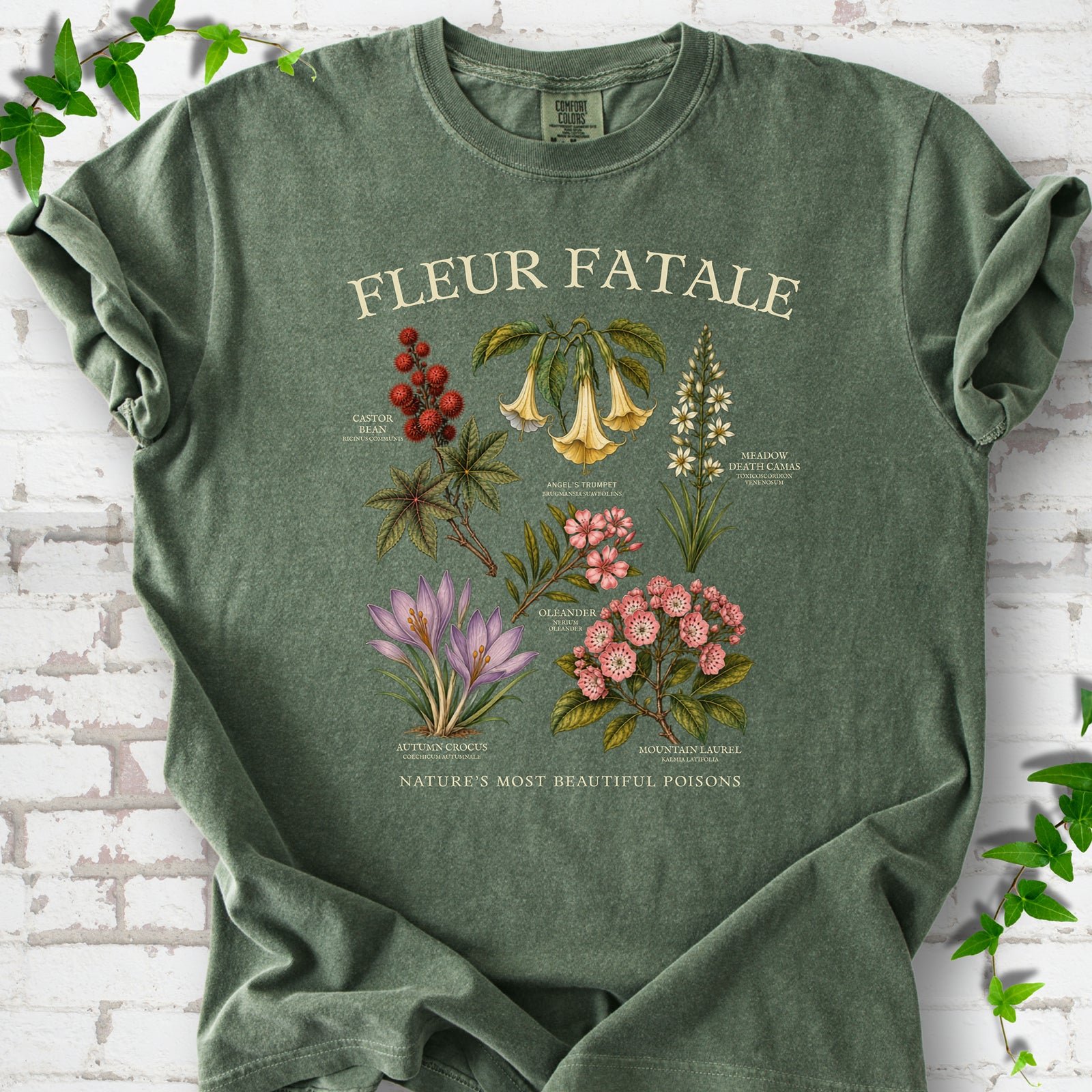 Moss Comfort Colors® T-shirt flat lay featuring a Fleur Fatale botanical chart of six poisonous flowering plants.