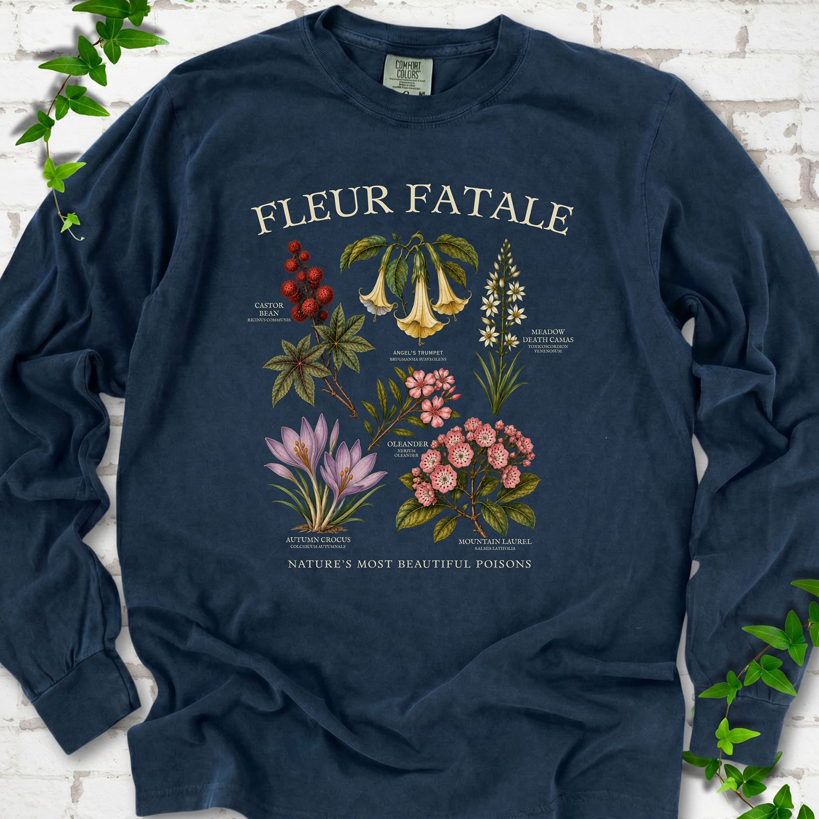 Midnight Comfort Colors® long sleeve T-shirt flat lay featuring a Fleur Fatale botanical chart of six poisonous flowering plants.
